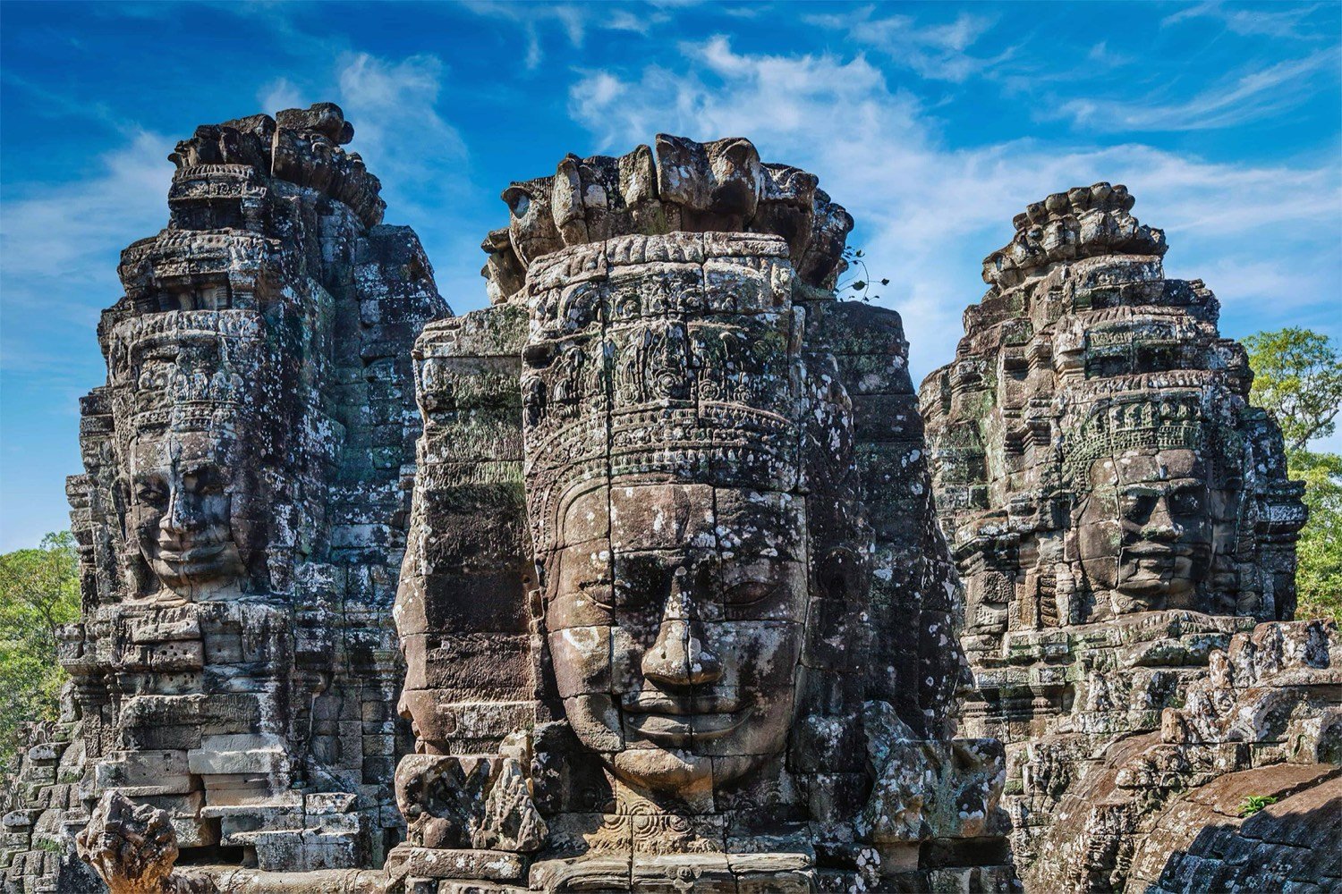A weathered stone figure at an Angkor temple